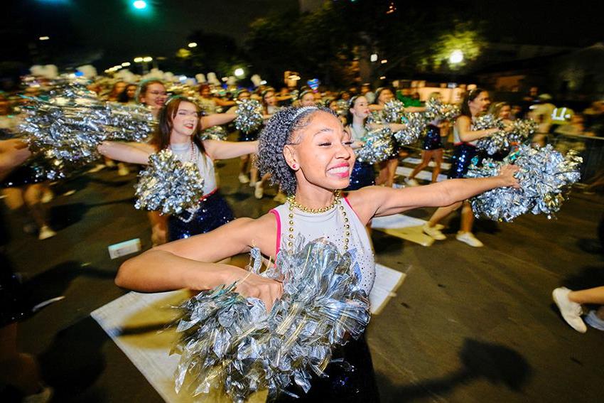 Cheerleader with her pom poms dancing