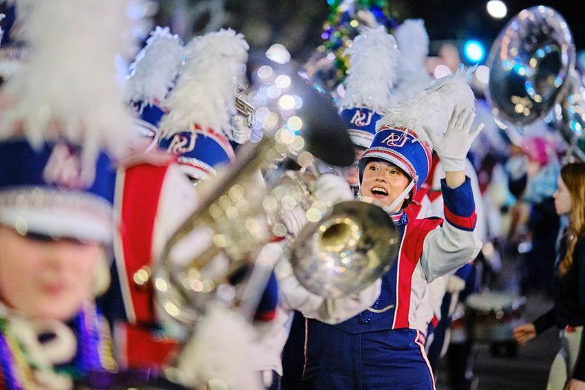 Jaguar Marching Band member waving and smiling