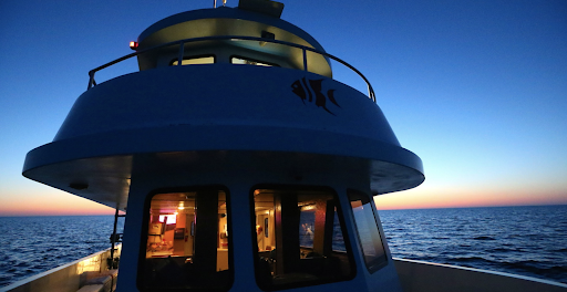 Boat on the water at night.